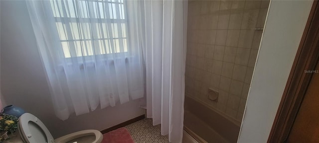 bathroom featuring toilet, tile floors, and shower / tub combination