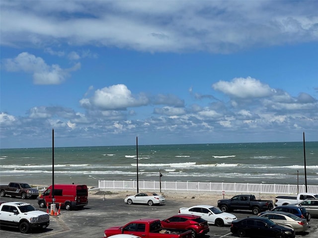 view of parking with a water view