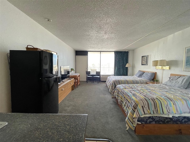 carpeted bedroom with a textured ceiling and black refrigerator