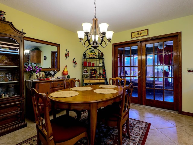 dining room featuring a chandelier, french doors, and light tile floors