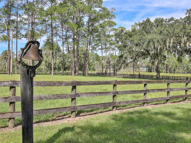 view of gate featuring a yard and a rural view