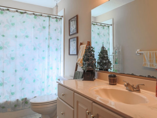 bathroom featuring toilet, tile flooring, and vanity