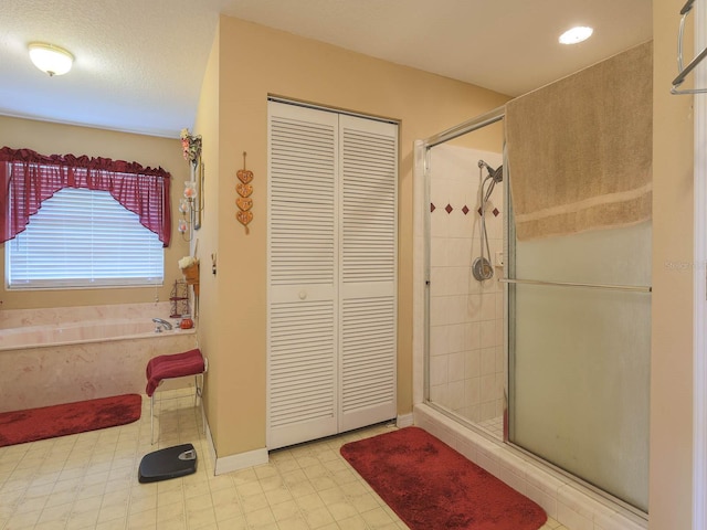 bathroom with tile floors and separate shower and tub