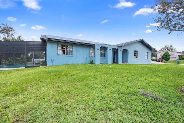 ranch-style home with a swimming pool and a front lawn