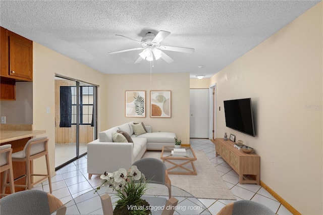 living room featuring light tile patterned flooring, a textured ceiling, and ceiling fan