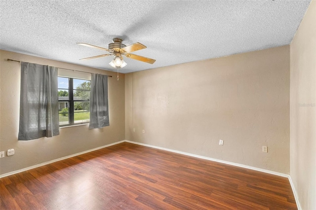 spare room with dark wood-type flooring, a textured ceiling, and ceiling fan