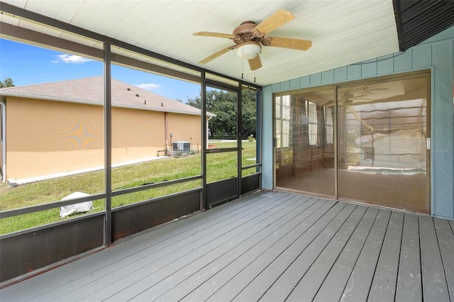 unfurnished sunroom featuring ceiling fan