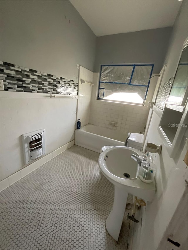 bathroom featuring a wall mounted AC, toilet, and tile flooring