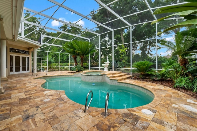 view of pool featuring a patio, glass enclosure, and an in ground hot tub