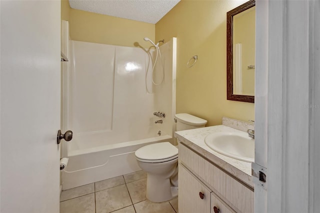 full bathroom with a textured ceiling, tile floors, toilet,  shower combination, and oversized vanity