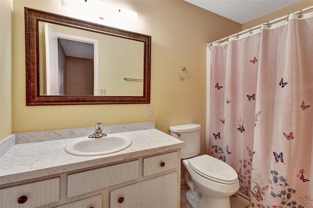 bathroom featuring tile flooring, vanity, toilet, and a textured ceiling