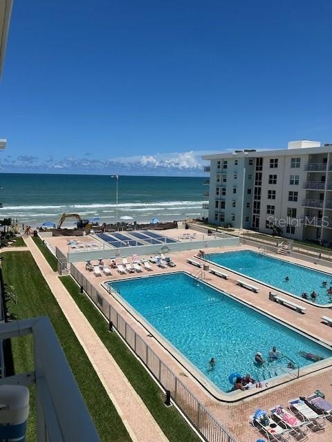 view of pool with a water view