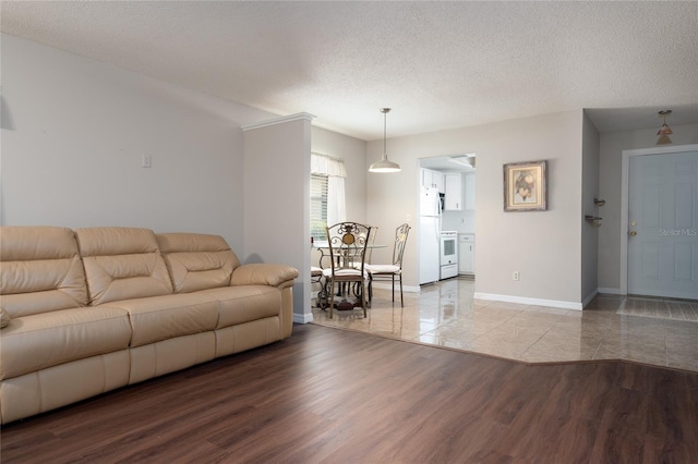 living room with hardwood / wood-style floors and a textured ceiling