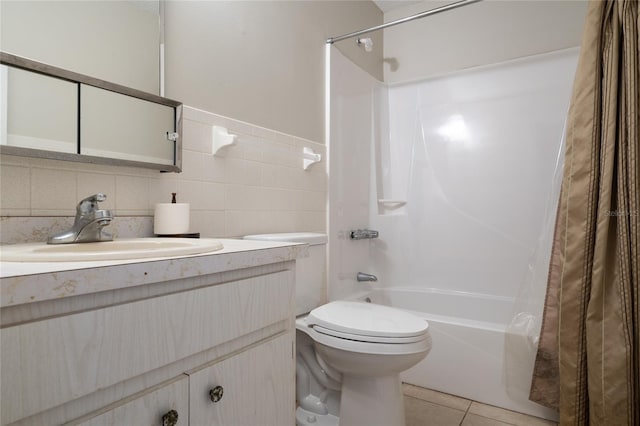 full bathroom with toilet, vanity, tile walls, tile patterned floors, and shower / bath combo