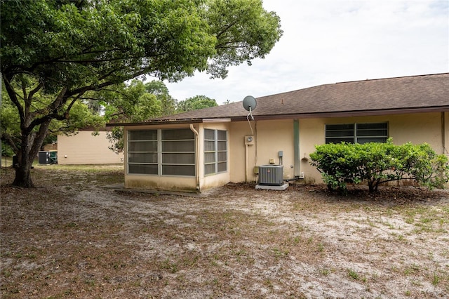 rear view of house with a sunroom and cooling unit