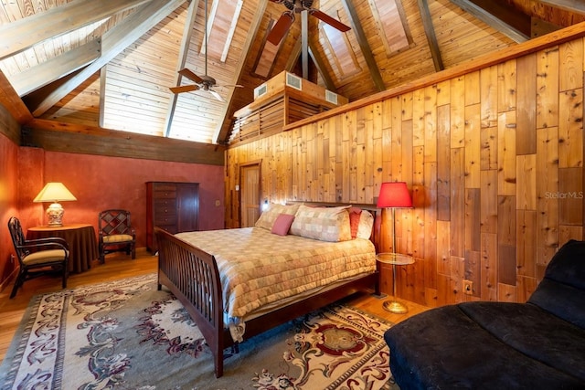 bedroom featuring wood walls, hardwood / wood-style floors, beamed ceiling, and wooden ceiling