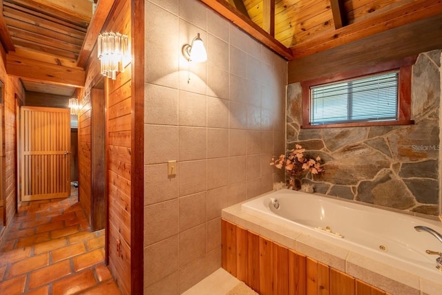 bathroom with a bath, beam ceiling, and wooden ceiling