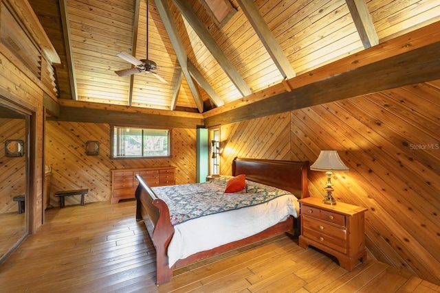 bedroom with light wood-type flooring, wood ceiling, wooden walls, high vaulted ceiling, and beamed ceiling