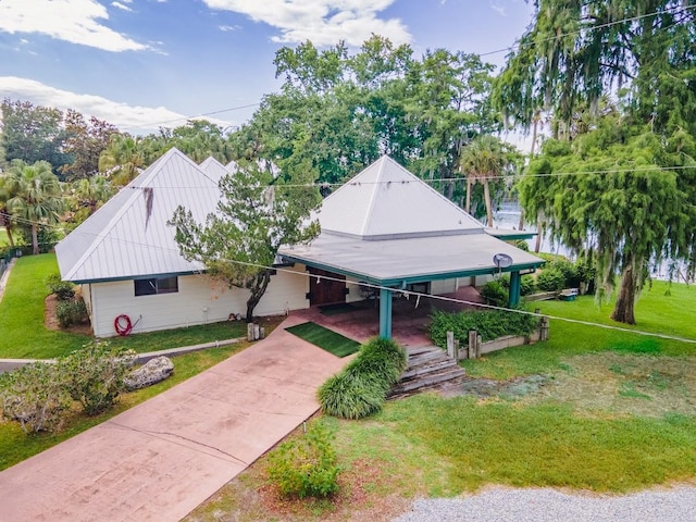 exterior space featuring a front lawn and a carport