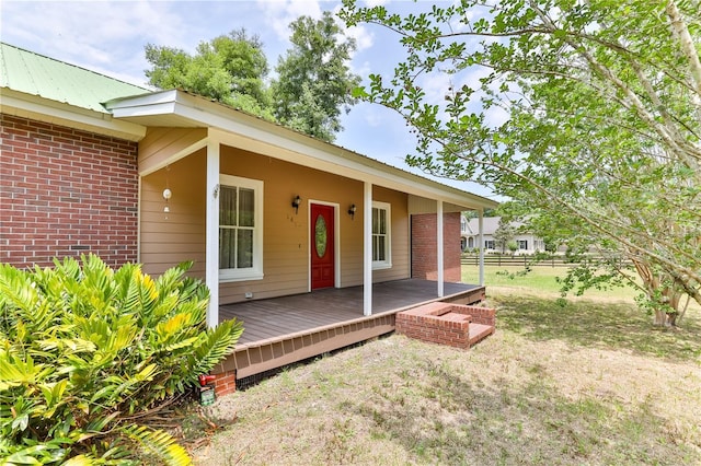 view of exterior entry featuring a deck