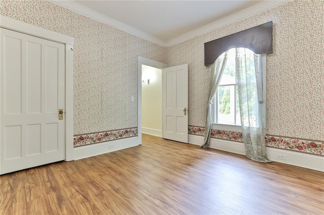 unfurnished bedroom with light hardwood / wood-style floors and ornamental molding