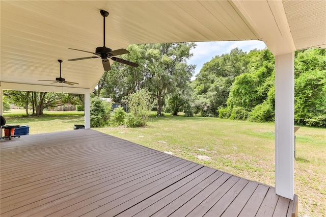 deck featuring a yard and ceiling fan