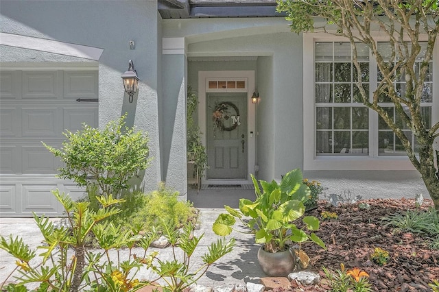 view of exterior entry with a garage