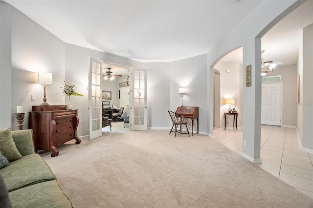 living room with ceiling fan and light colored carpet