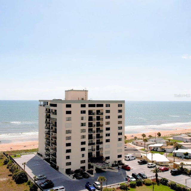 view of property with a beach view and a water view