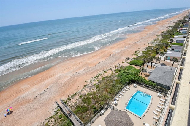 birds eye view of property with a beach view and a water view