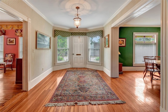 doorway to outside featuring light wood-type flooring and crown molding