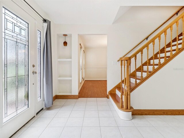 entryway with light tile patterned floors