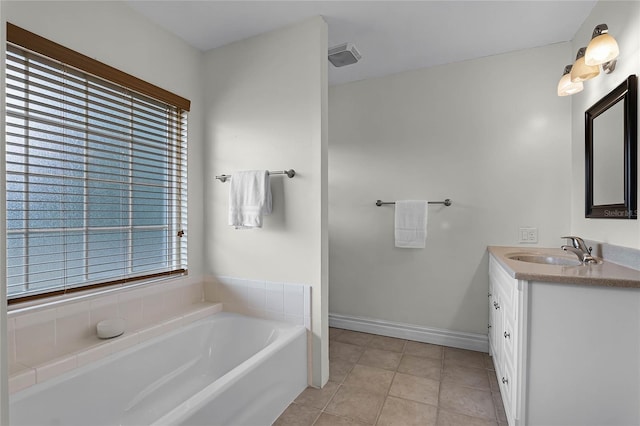 bathroom with tile patterned flooring, vanity, and a washtub