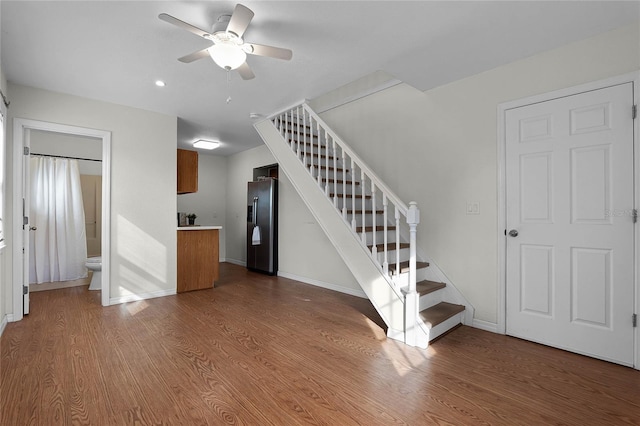 unfurnished living room with hardwood / wood-style floors and ceiling fan