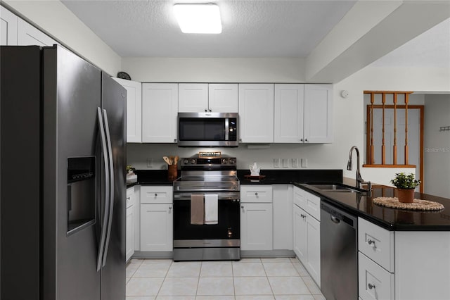 kitchen featuring white cabinetry, sink, a textured ceiling, and appliances with stainless steel finishes