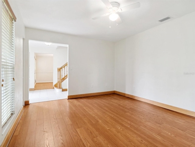 empty room with ceiling fan and light wood-type flooring