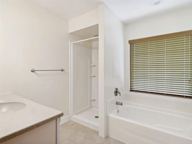 bathroom with tile patterned floors, vanity, and a bath