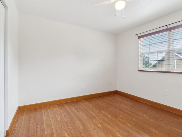 spare room with ceiling fan and hardwood / wood-style flooring