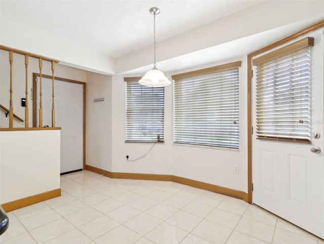 unfurnished dining area featuring light tile patterned floors