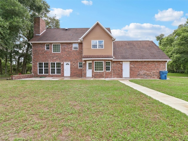 rear view of house with a lawn