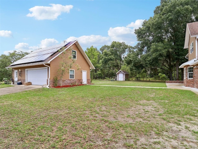 view of home's exterior featuring solar panels, a yard, a garage, and a storage unit