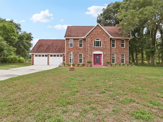 colonial home featuring a garage and a front lawn