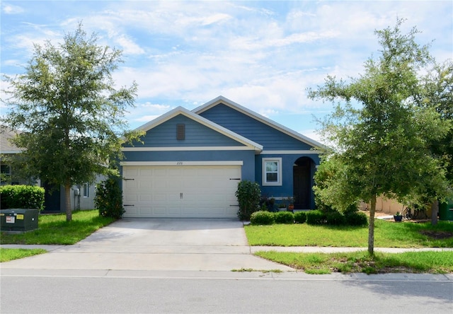 view of front of property featuring a garage and a front lawn