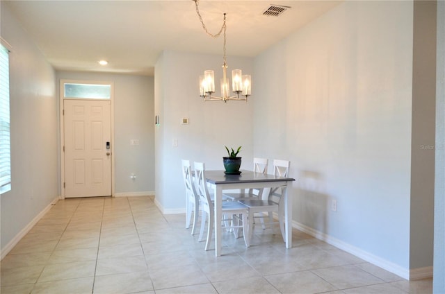 unfurnished dining area featuring a chandelier and light tile floors