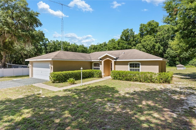 ranch-style house featuring a garage and a front lawn