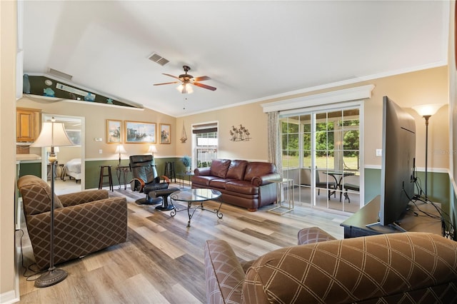 living room with crown molding, hardwood / wood-style flooring, lofted ceiling, and ceiling fan