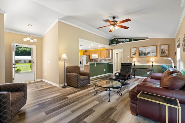 living room featuring lofted ceiling, ceiling fan with notable chandelier, crown molding, and hardwood / wood-style flooring