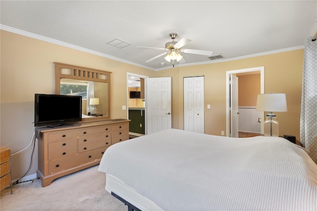 bedroom featuring ceiling fan, a closet, ensuite bathroom, light colored carpet, and ornamental molding