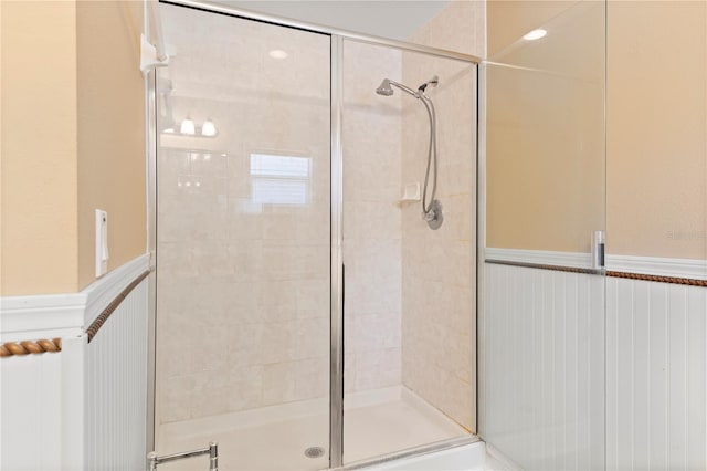 bathroom with a shower with door