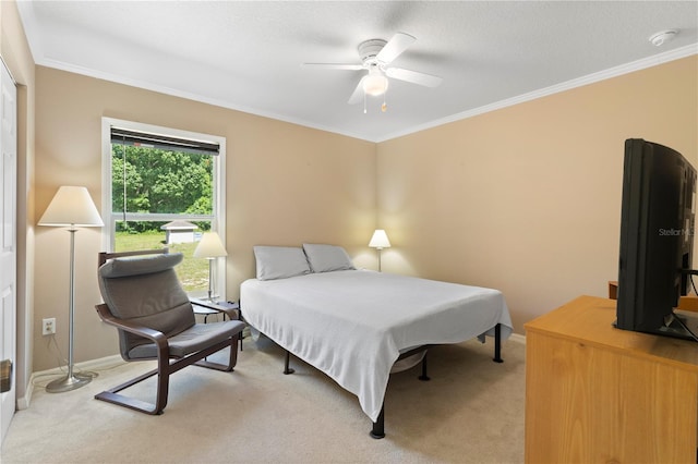 carpeted bedroom with ornamental molding and ceiling fan